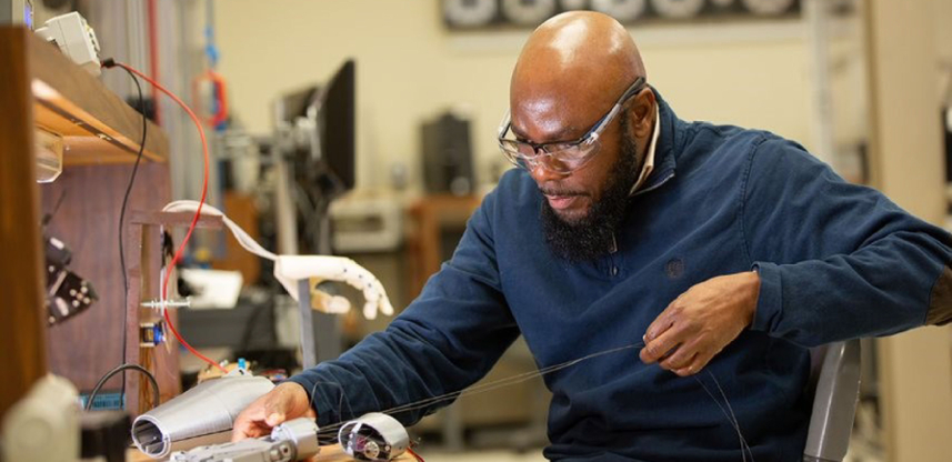 Student working on a robotic hand