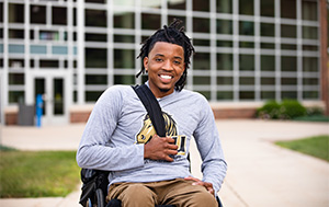 Student in wheel chair on campus.